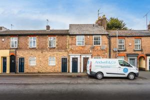 a van parked in front of a brick building at Jasmin Place in Luton