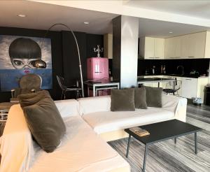 a living room with a white couch and a kitchen at Zen Townhouse - Infinity Seaview in Palaiokastro +25 photos