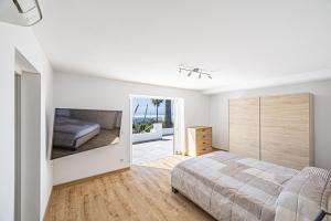 a bedroom with a large bed and a mirror at Villa Las Norias in Tazacorte +46 photos