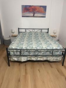 a large bed in a bedroom with two tables at La Casuzza del Borgo in Agrigento
