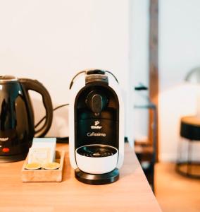 a coffee maker sitting on top of a wooden table at Suite Dreams Bremen in Bremen