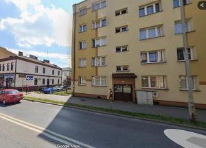 a large yellow building on the side of a street at Apartament TARNÓW LWOWSKA CENTRUM in Tarnów
