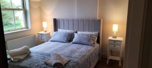 a bedroom with a large bed with two lamps at Roseville in Limerick