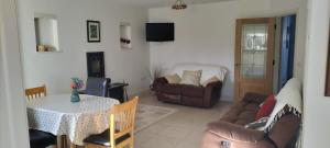 a living room with a couch and a table at Roseville in Limerick