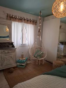 a bedroom with a hammock hanging from the ceiling at Au Jardin d'Armand in Sant Pere de Ribes
