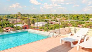 a balcony with a swimming pool on top of a building at Civis Jardinia Sky Studio 4B Pool & Sauna in Luque