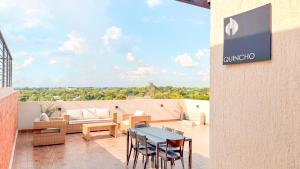 a patio with a table and chairs and a couch at Civis Jardinia Studio 1B Pool & Sauna in Luque