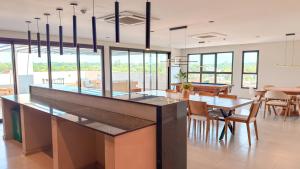 a kitchen with a large island with a table and chairs at Civis Jardinia Studio 1B Pool & Sauna in Luque