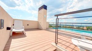 a balcony with a view of a swimming pool at Civis Jardinia Studio 1B Pool & Sauna in Luque
