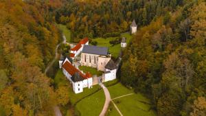an aerial view of a large house in a forest at Apartma Valerija in Zreče