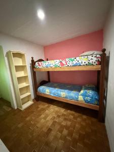 a bedroom with two bunk beds and a shelf at Le de nery in Ostende