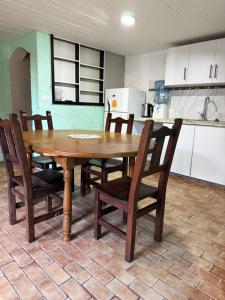 a wooden table and chairs in a kitchen at Le de nery in Ostende