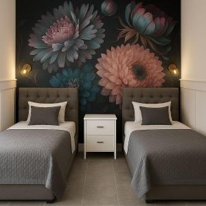 two beds in a room with flowers on the wall at Mazury Apartamenty wodne tarasy Blue - Ruś in Ruś