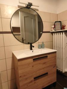 a bathroom sink with a mirror on top of it at S'heimet Hüüs in Colmar +14 photos