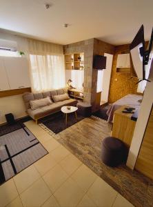 a living room with a couch and a table at Студио Нико - Царево in Tsarevo