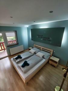 a bedroom with a large bed with two pillows at Mézi Lazy in Gyenesdiás