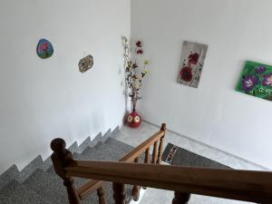 a room with a staircase with pictures on the wall at La casetta verde in Villa Verde +22 photos