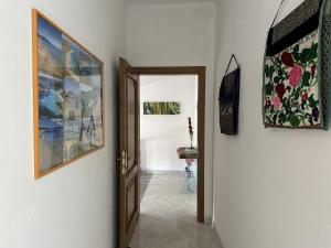 a hallway with two pictures on the wall and a door at La casetta verde in Villa Verde