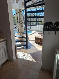 a hallway with a spiral staircase in a house at Au Jardin d'Armand in Sant Pere de Ribes