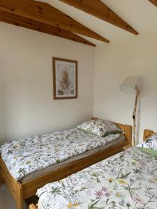 two beds in a room with white walls at Święty Spokój Bielinek balia jacuzzi taras Chojna Cedynia in Cedynia