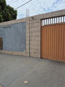 a brick building with a large garage door at Apartamento confortável em Cuiabá in Cuiabá
