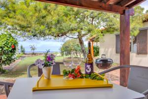 a table with a bottle of wine and glasses on it at Casa Punta del Viento Tenerife in El Pris