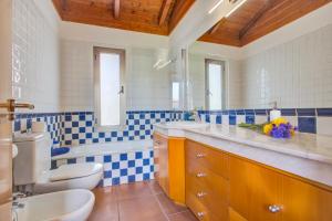 a bathroom with a toilet and a tub and a sink at Casa Punta del Viento Tenerife in El Pris +22 photos