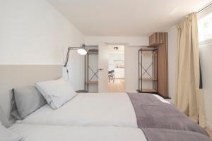a bedroom with a white bed and a window at Coliving Torremolinos Casa privada in Torremolinos +36 photos