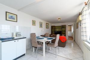 a kitchen and dining room with a table and chairs at Apartment Tena in Kraljevica