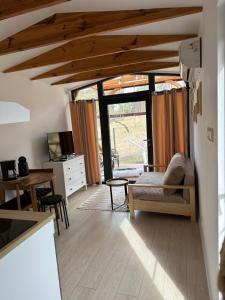 a living room with wooden ceilings and a table and chairs at Święty Spokój Bielinek balia jacuzzi taras Chojna Cedynia in Cedynia