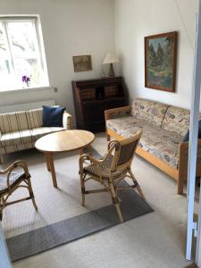 a living room with a couch and a table at Vejlø Skole - Degnegaarden in Næstved +12 photos