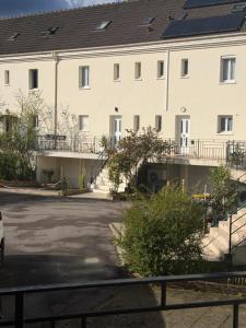 a building with solar panels on the roof at Maison familiale in Gonesse
