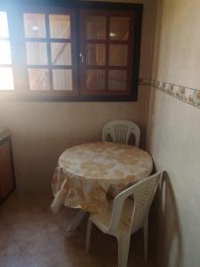 a table and chairs in a room with a window at Premium Services in Tatta