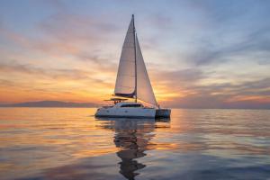 a sailboat on the water at sunset at Nuit en Catamaran aux Iles de Lérins in Cannes