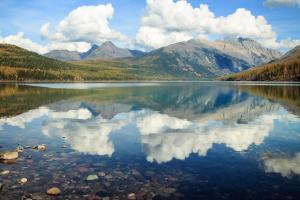 a reflection of the mountains in a lake at Big Sky Ski Condo in Big Sky