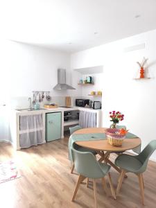 a kitchen and dining room with a table and chairs at Casa con vista in Ariccia
