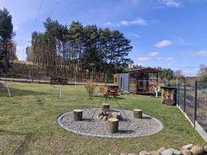 a park with a playground with a fire pit at Święty Spokój Bielinek balia jacuzzi taras Chojna Cedynia in Cedynia