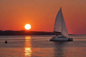 a sail boat in the water at sunset at Nuit en Catamaran aux Iles de Lérins in Cannes +2 photos