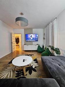 a living room with a couch and a table at Happy Place Făgăraș in Făgăraş