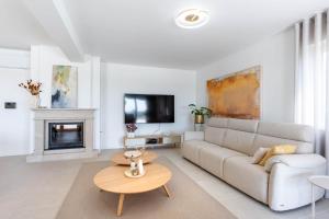 a living room with a couch and a table at NEW! Villa Rabella - Luxury Oasis, Island Rab in Rab