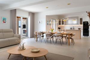 a living room and kitchen with a table and chairs at NEW! Villa Rabella - Luxury Oasis, Island Rab in Rab