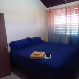 a bedroom with a bed with blue sheets and a phone on it at Tambell Haven in Runaway Bay +45 photos