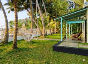 a hammock in a yard next to a house at Kumarakom Homes in Kumarakom