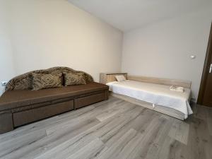 a room with a bed and a couch in it at Guest House STEVi in Devin