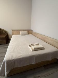 a bedroom with a bed with a white bedspread at Guest House STEVi in Devin
