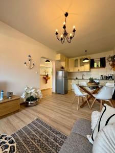 a living room and kitchen with a table and chairs at Apartment Fortuna in Korčula
