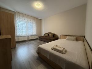 a bedroom with a bed and a couch and a window at Guest House STEVi in Devin +28 photos