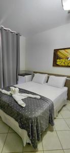 a bedroom with two beds and a table with a blanket at Pousada Costa do Sol in Aracruz +35 photos