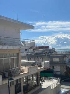 a view of a building with mountains in the background at Megalou Alexandrou in Nea Moudania
