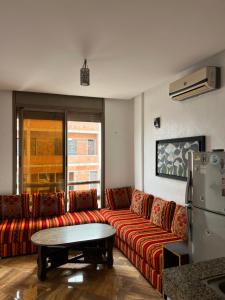 a living room with a couch and a table at Guest house in Imsouane